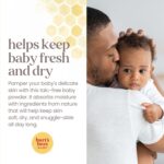 A white bottle of Burt's Bees Baby Dusting Powder with a yellow label and a picture of a baby.