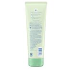 Close-up of a bottle of creamy baby oil with aloe and vitamin E, designed for moisturizing delicate skin.